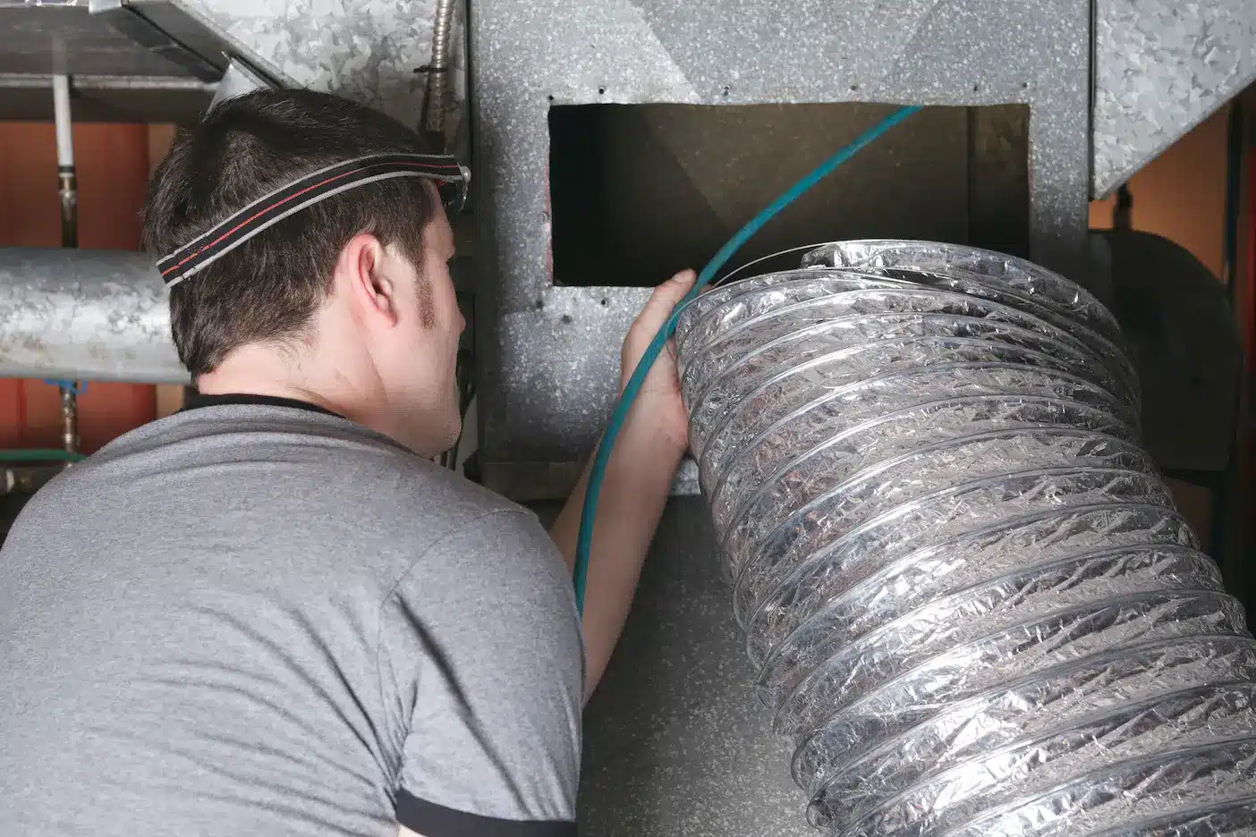 man cleaning air duct